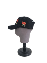 Side view of black corduroy Palestine snapback hat with 11:11 logo and embroidered watermelon slice. pro-Palestine streetwear with distressed brim and symbolic design.